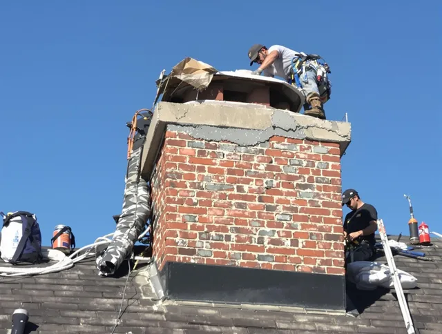 Bellingham Chimney Sweep installing a custom chimney crown in Bellingham, MA