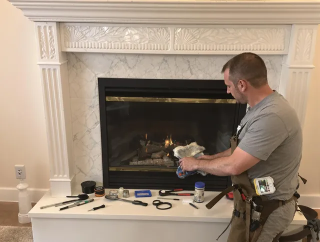 Bellingham Chimney Sweep performing fireplace maintenance in Bellingham, MA
