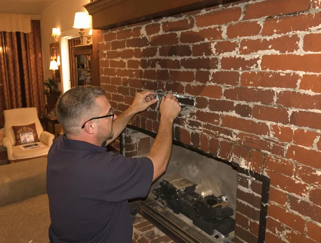 Bellingham Chimney Sweep expert fixing a fireplace in Bellingham, MA
